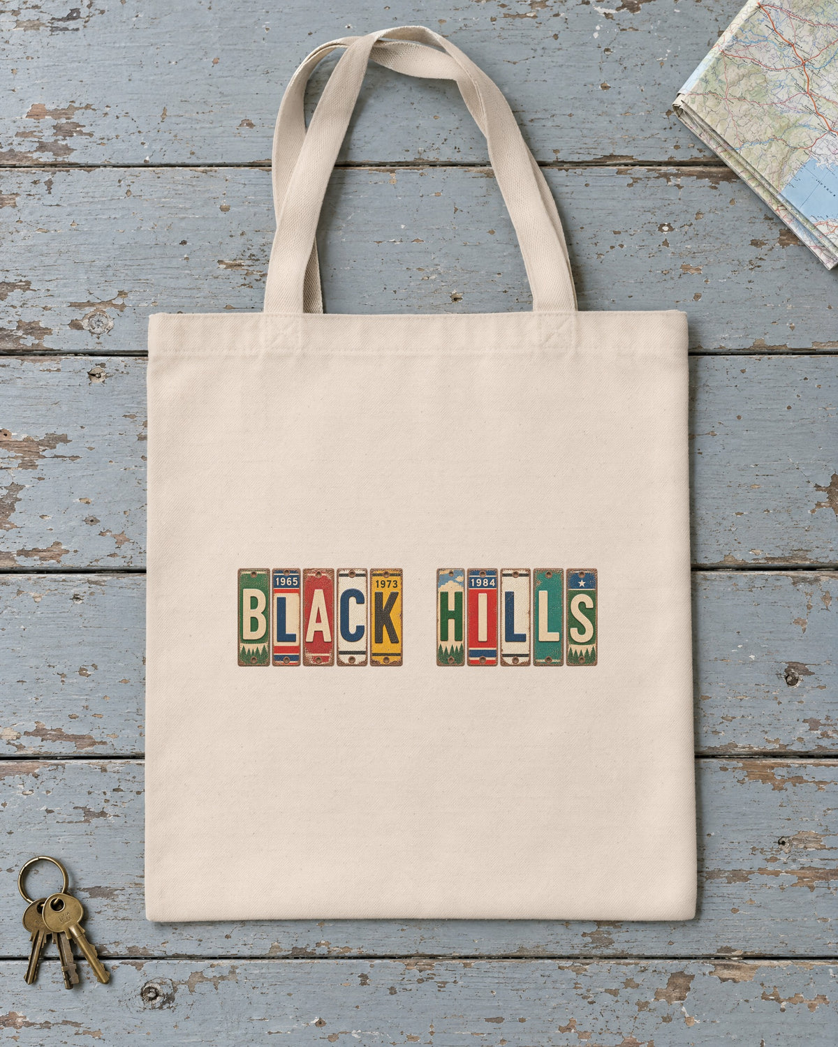 Black Hills, South Dakota vintage license plate tote bag in Natural