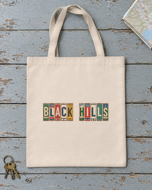 Black Hills, South Dakota vintage license plate tote bag in Natural